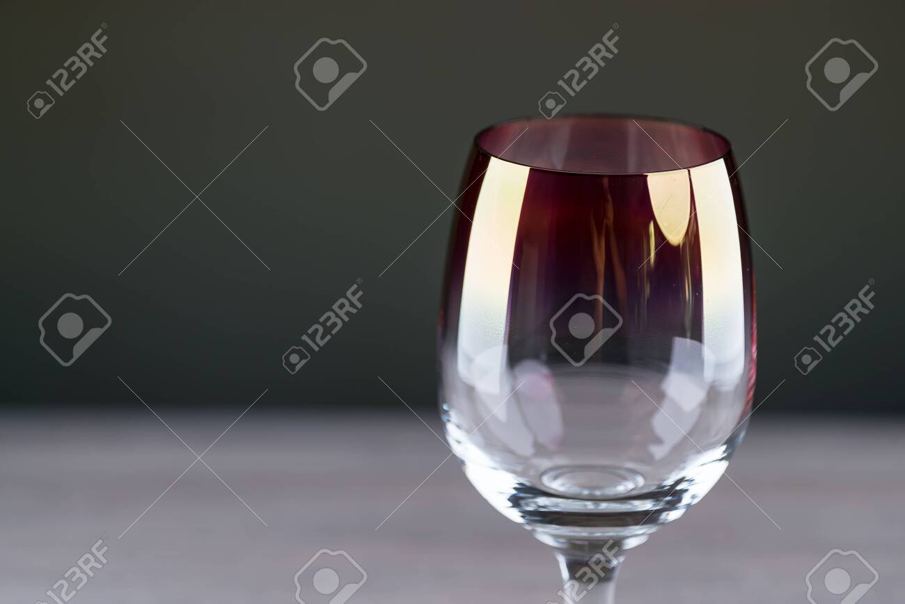 Pouring red wine from a bottle into a wineglass: wine tasting and celebration - 144316165 Pouring red wine from a bottle into a wineglass: wine tasting and celebration - 144316165