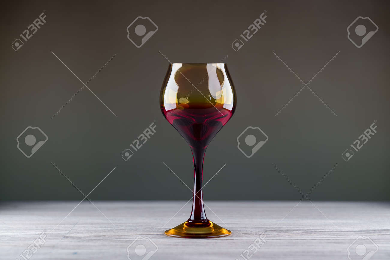 Pouring red wine from a bottle into a wineglass: wine tasting and celebration - 144316198 Pouring red wine from a bottle into a wineglass: wine tasting and celebration - 144316198
