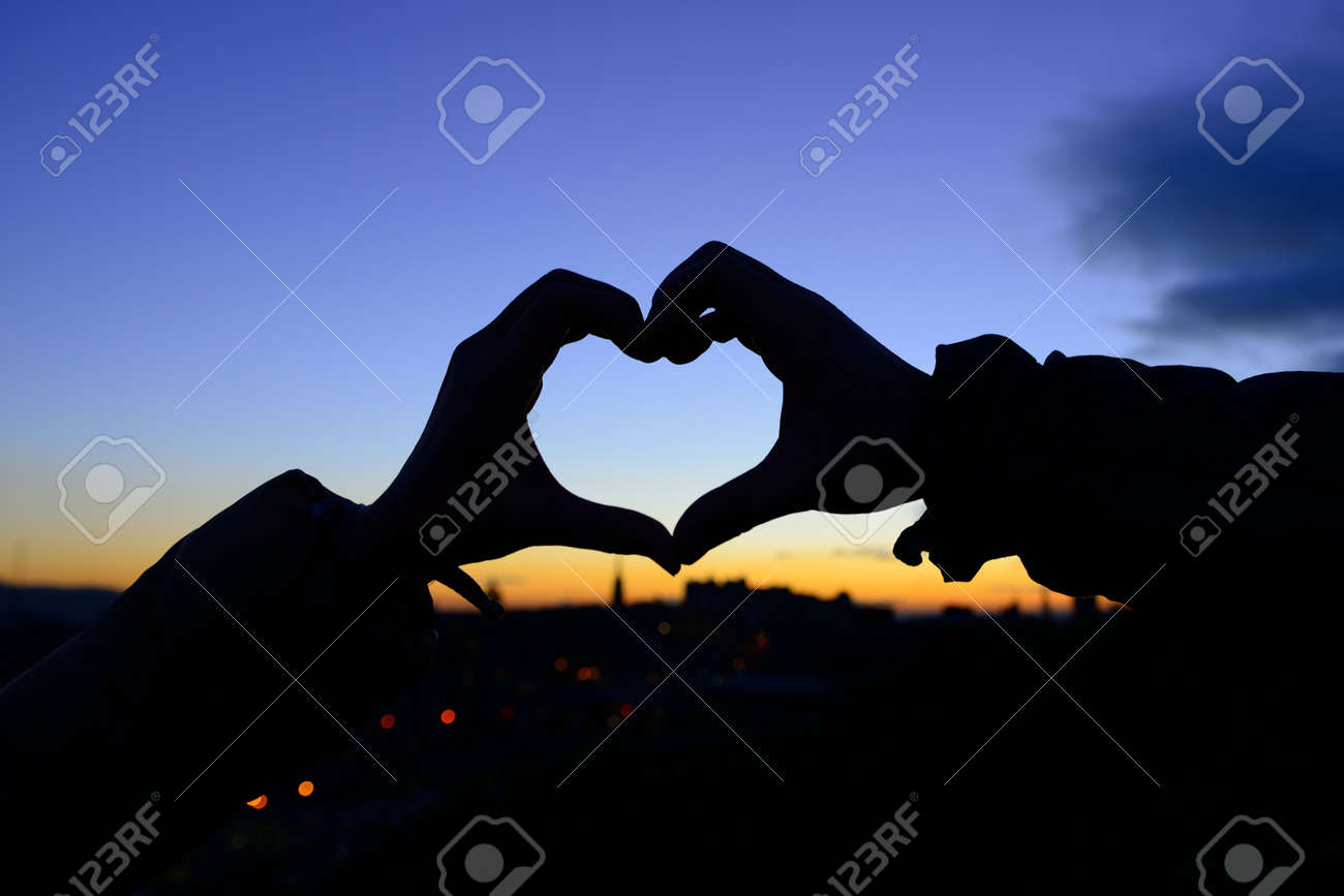Silhouette Of Hands In Form Of Heart When Sweethearts Have Touched In  Autumn With Sunset At City Background Stock Photo, Picture and Royalty Free  Image. Image 16240416., image size:1300x867
