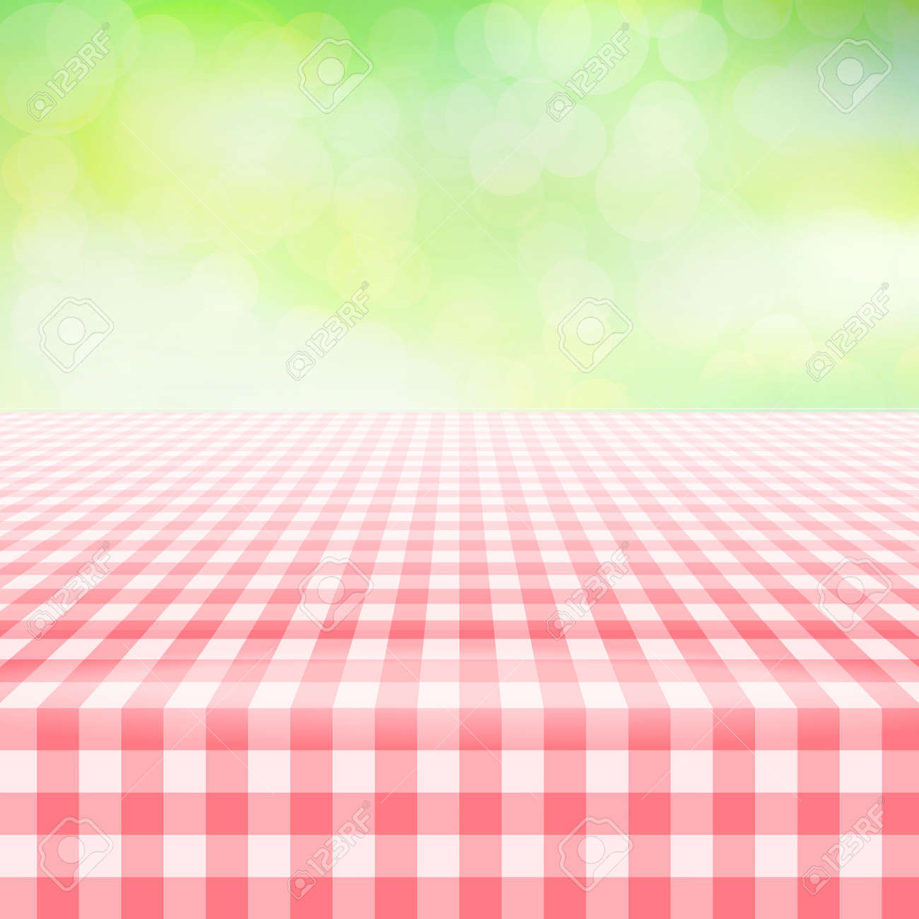 empty picnic table covered with checkered gingham tablecloth