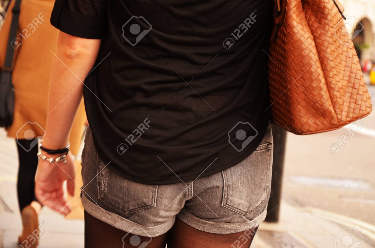 A hot girl is wearing shorts and is equipped with a stylish handbag - 15763134 A hot girl is wearing shorts and is equipped with a stylish handbag - 15763134