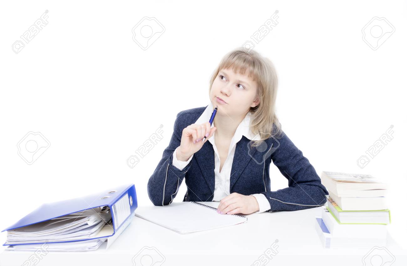 A young woman is sitting at the desk and is studying - 24703240 A young woman is sitting at the desk and is studying - 24703240