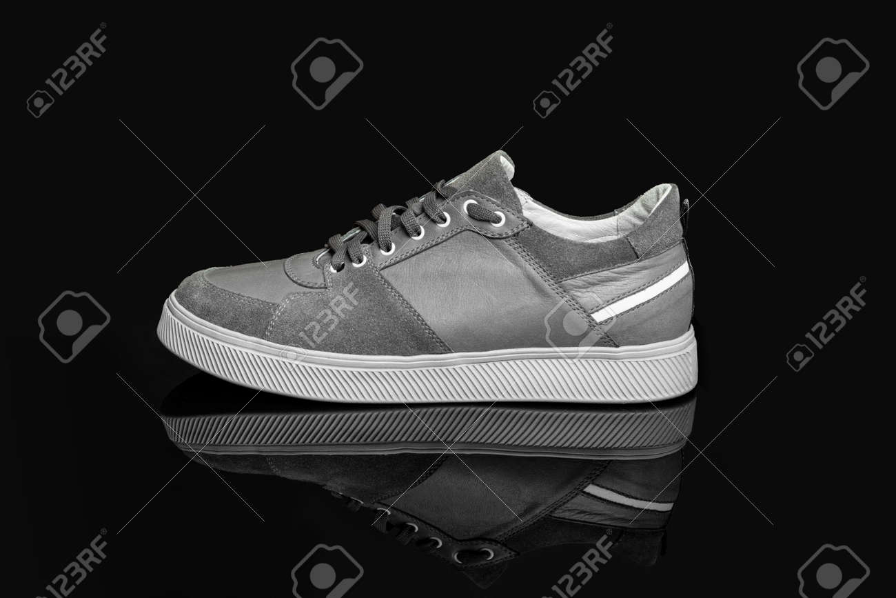 Gray casual sports shoes, sneaker isolated on a black background - 170242765 Gray casual sports shoes, sneaker isolated on a black background - 170242765