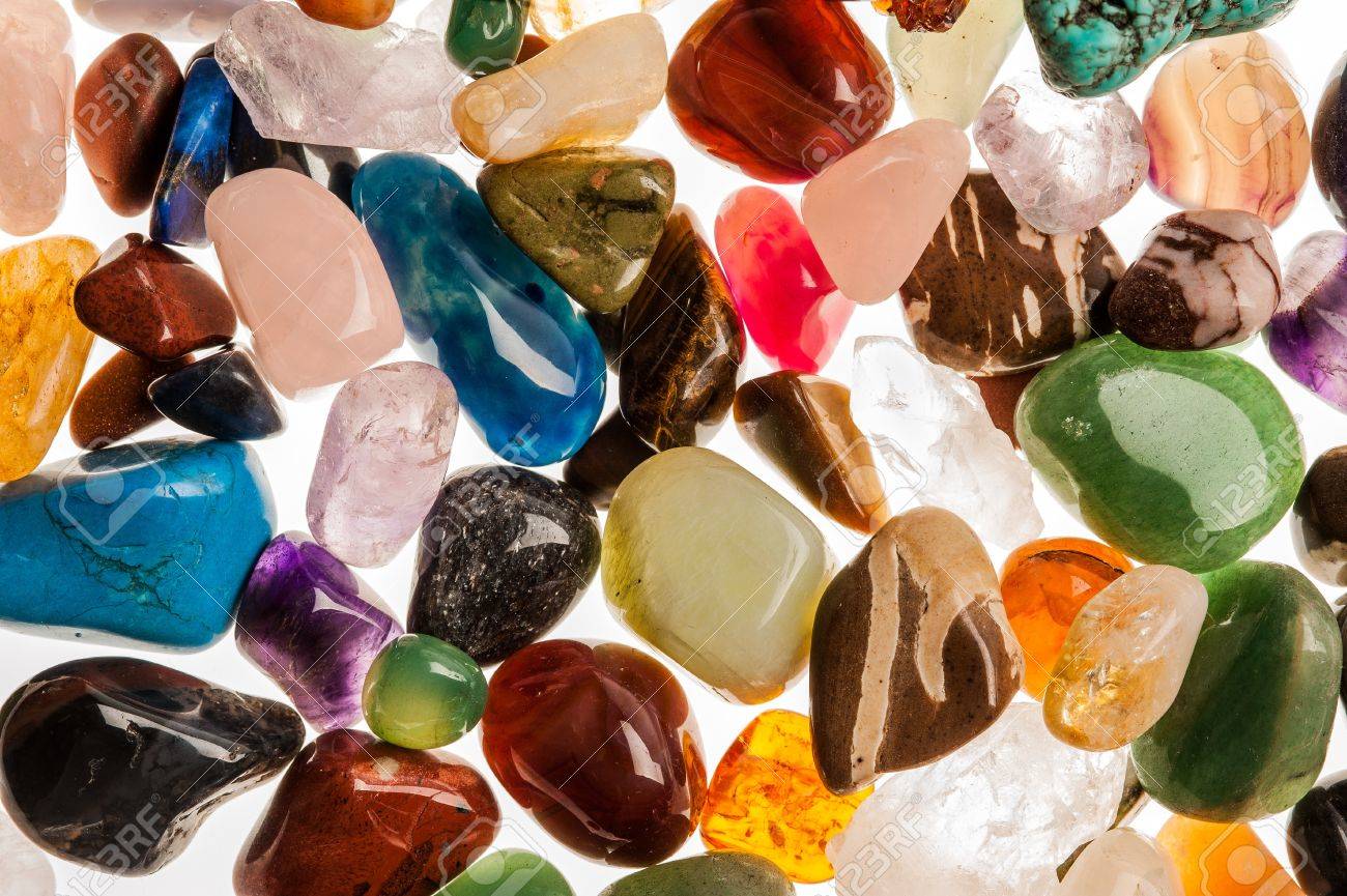 Assortment of polished semi-precious gem stones shot in the studio against white background - 19593283 Assortment of polished semi-precious gem stones shot in the studio against white background - 19593283