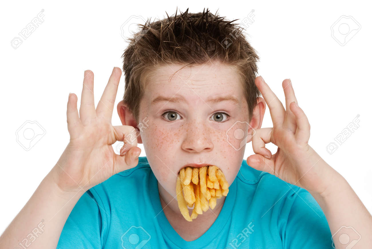 Young boy with a mouth full of chips fries. Isolated on white background. - 20726336 Young boy with a mouth full of chips fries. Isolated on white background. - 20726336
