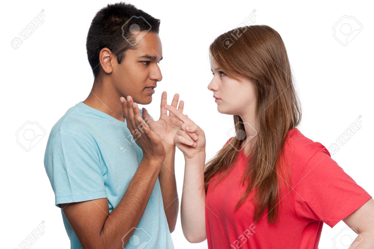 Teenagers in arguement. Girl accusing. Boy defending. Studio shot. White background. - 39787054 Teenagers in arguement. Girl accusing. Boy defending. Studio shot. White background. - 39787054