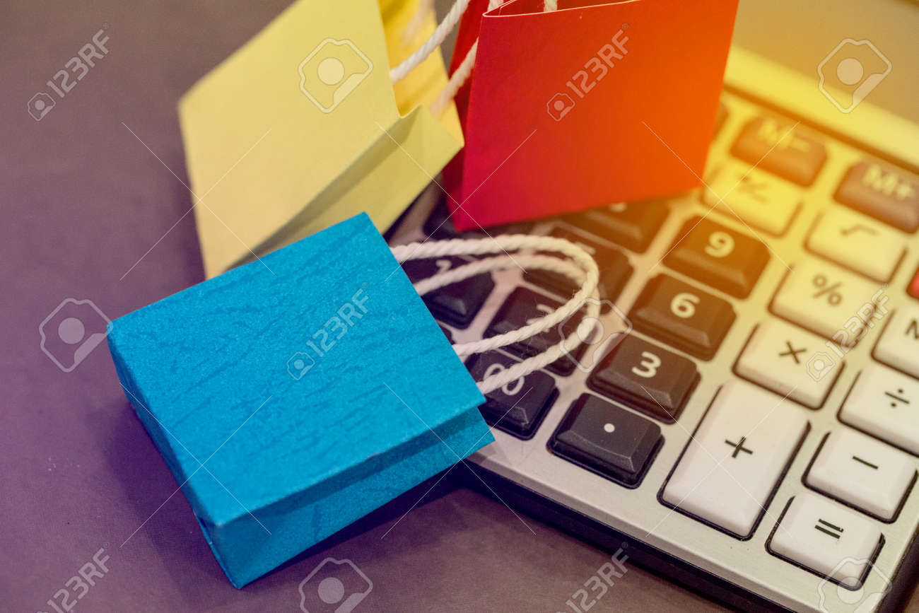closeup shot of blue color paper shopping bags on a calculator