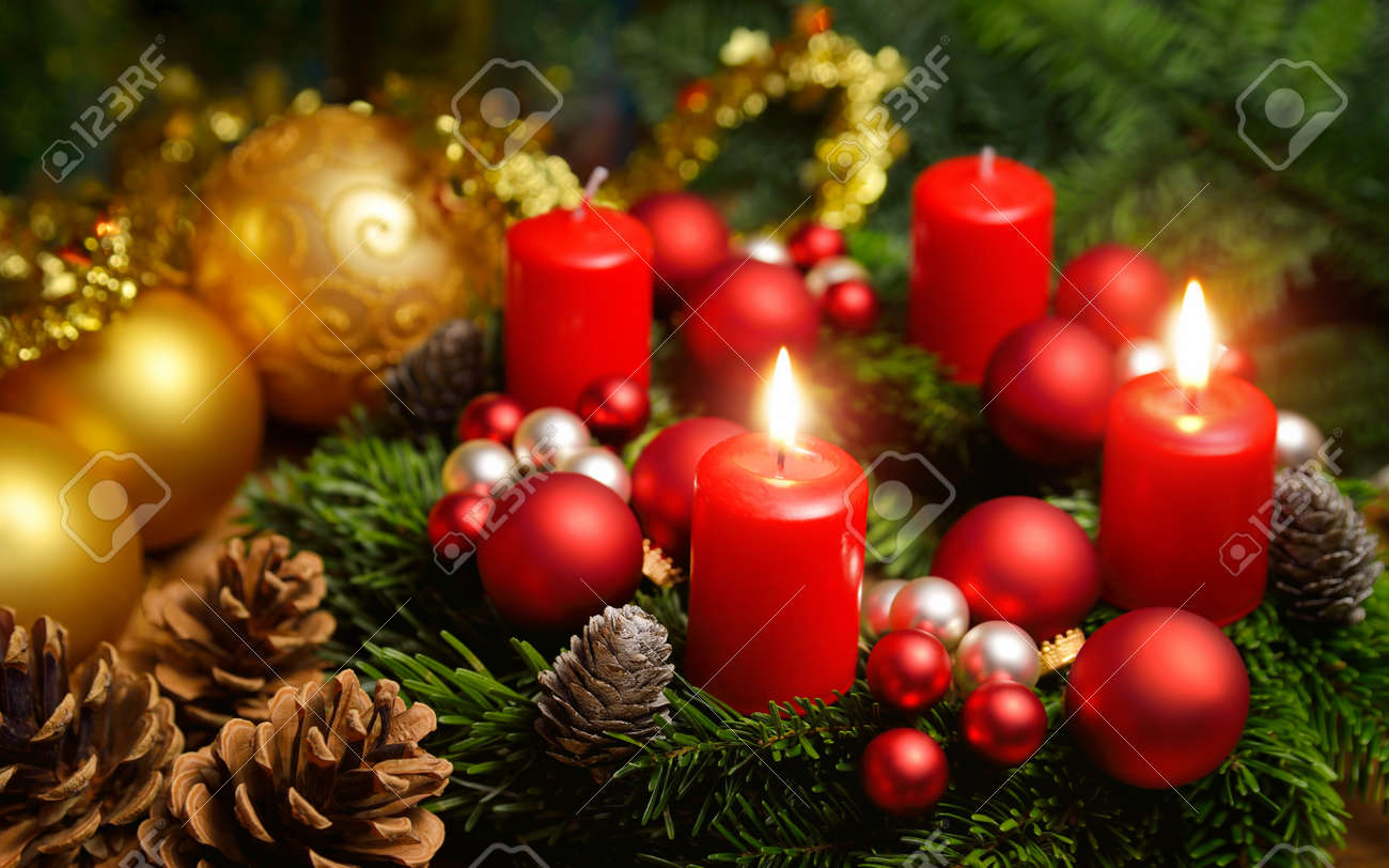 Studio shot of a nice advent wreath with baubles and two burning red candles - 47249366 Studio shot of a nice advent wreath with baubles and two burning red candles - 47249366