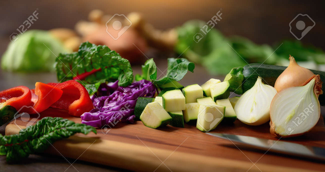Cooking vegetables on a wooden cutting board. A closeup with shallow focus showing colorful, nutritious and delicious food ingredients as a healthy lifestyle concept. - 148545785 Cooking vegetables on a wooden cutting board. A closeup with shallow focus showing colorful, nutritious and delicious food ingredients as a healthy lifestyle concept. - 148545785