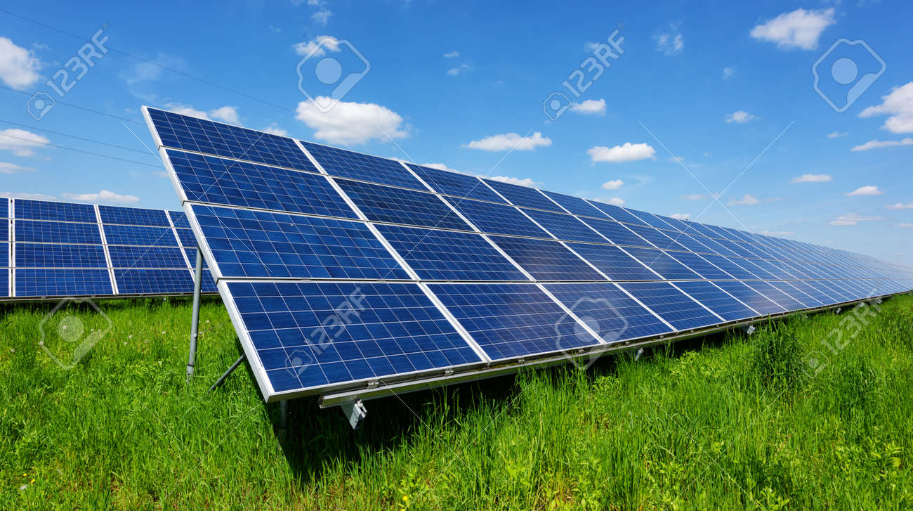 Solar panel on blue sky background. Green grass and cloudy sky. Alternative energy concept - 92057664 Solar panel on blue sky background. Green grass and cloudy sky. Alternative energy concept - 92057664