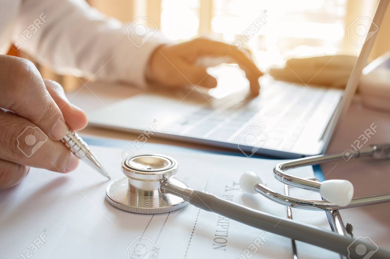 medicine doctor s writing on laptop in medical office focus