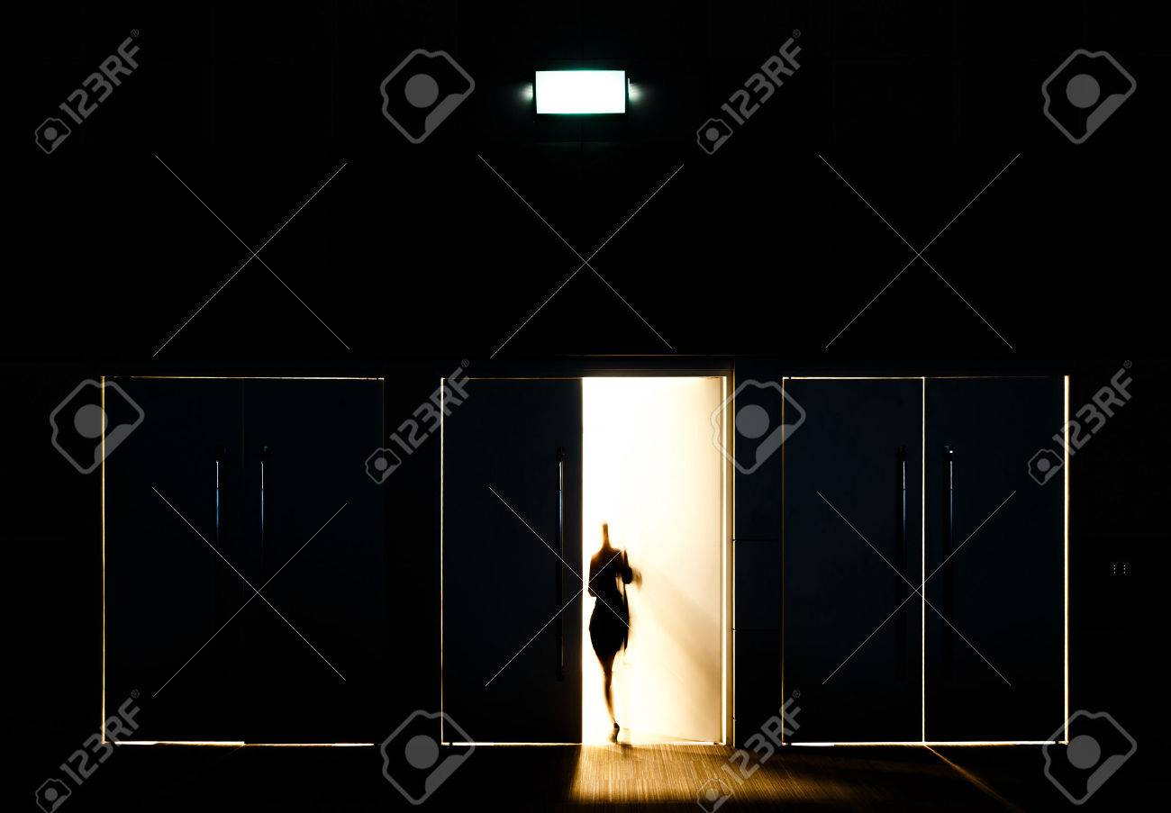 Door opened with motion blur of a man and light coming through the space - 32248227 Door opened with motion blur of a man and light coming through the space - 32248227