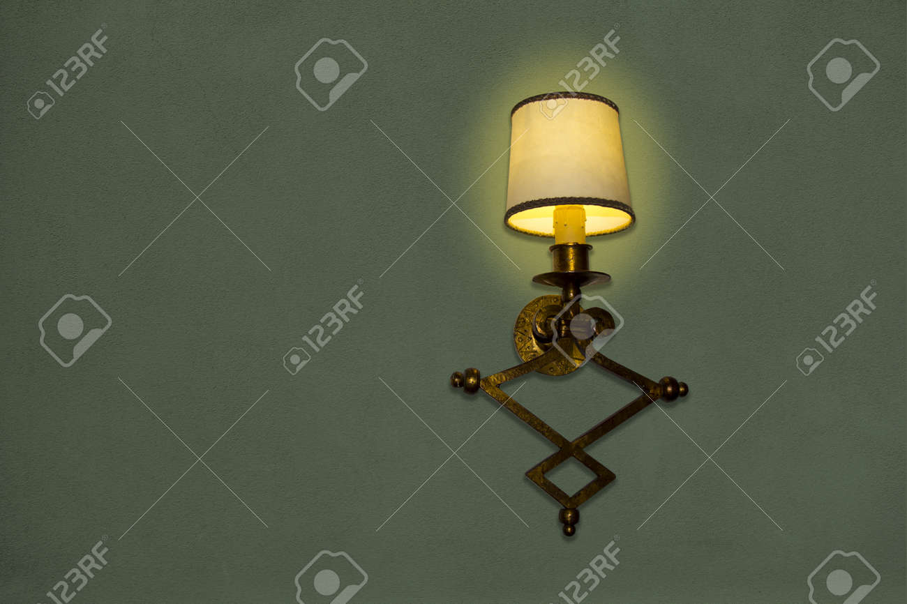 old wall lamp made of metal with shade from canvas stock photo