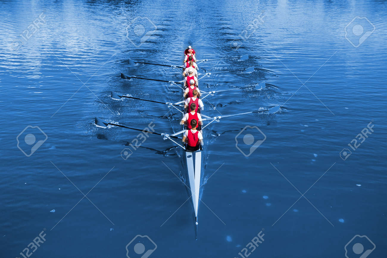 Boat coxed eight Rowers rowing on the blue lake. - 143163582 Boat coxed eight Rowers rowing on the blue lake. - 143163582
