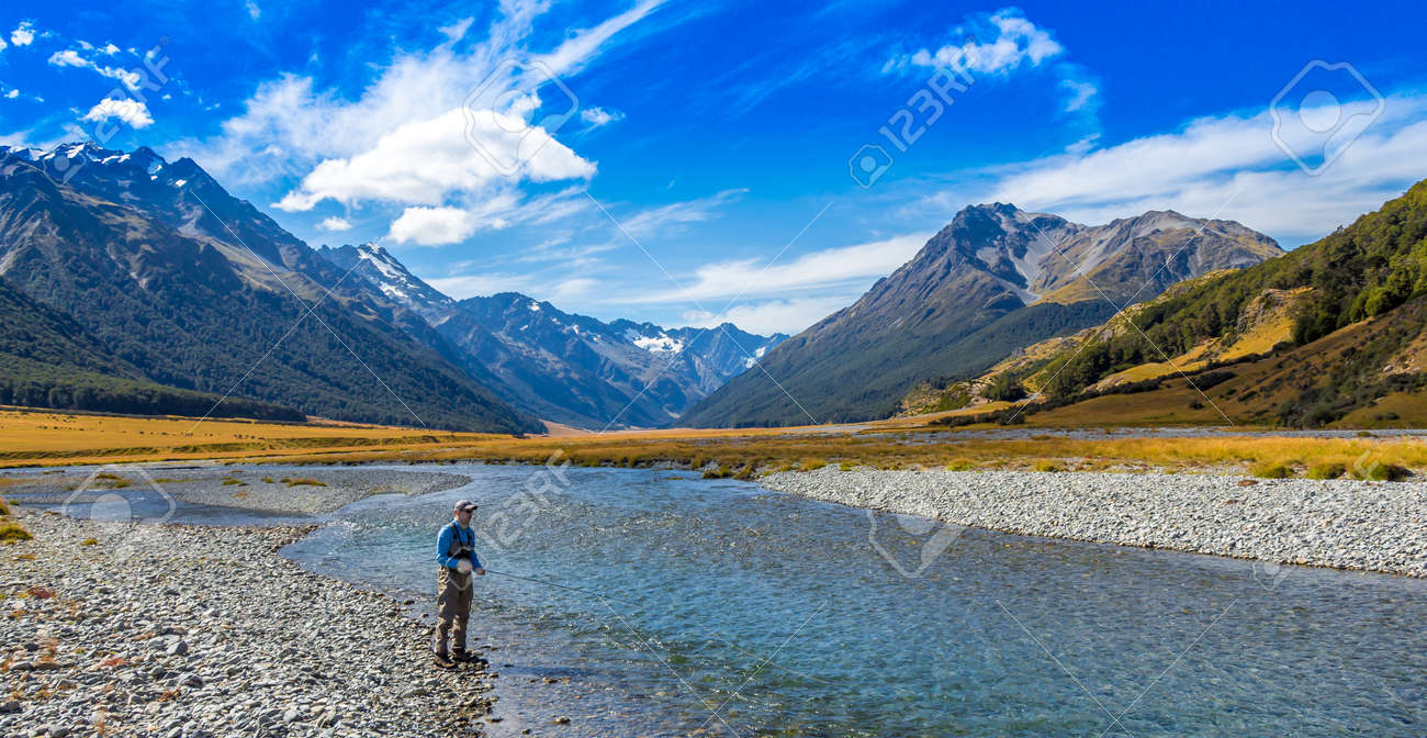 An Angler Fly Fishing For Trout On The Ahuriri River Surrounded Stock Photo Picture And Royalty Free Image Image