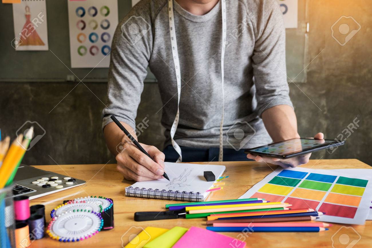 men working as fashion designer drawing sketches for clothes..