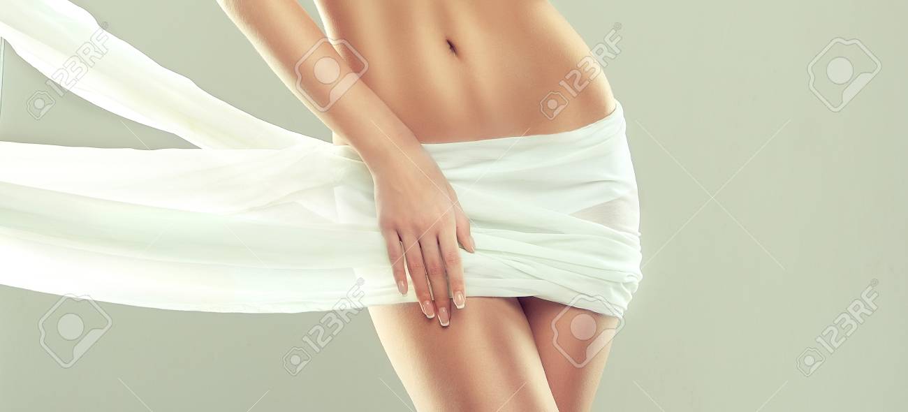Part of attractive woman body, hips and slender toned belly, covered by tender, silk textile. Graceful female figure, as a symbol of health and harmony. Well posing model is demonstrating elegant gesture and healthy, graceful figure. - 100193868 Part of attractive woman body, hips and slender toned belly, covered by tender, silk textile. Graceful female figure, as a symbol of health and harmony. Well posing model is demonstrating elegant gesture and healthy, graceful figure. - 100193868