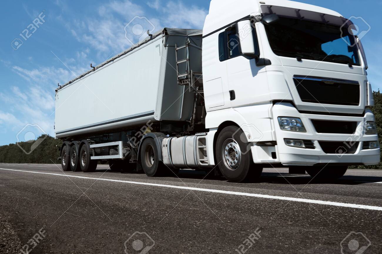 truck on the road, front view, empty space on a white container - concept of cargo transportation, trucking industry - 153028735 truck on the road, front view, empty space on a white container - concept of cargo transportation, trucking industry - 153028735