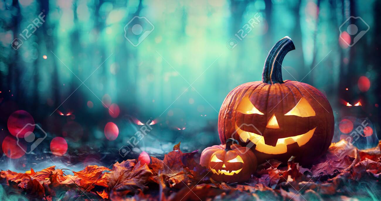 Jack O 'Lanterns On Red Leaves In Spooky Forest With Defocused Ghosts - 154194300 Jack O 'Lanterns On Red Leaves In Spooky Forest With Defocused Ghosts - 154194300