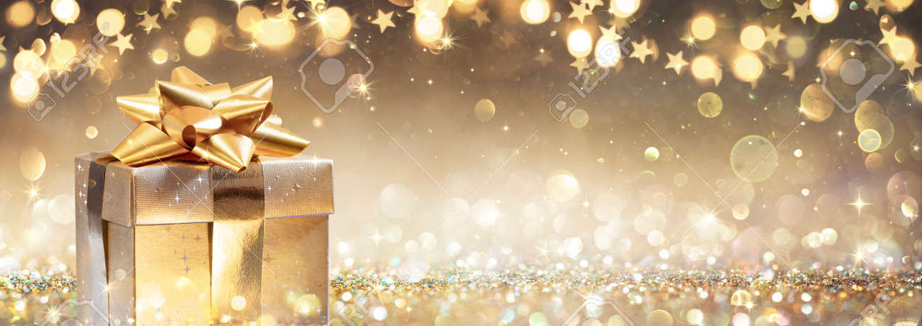 Golden Gift Box On Glitter In Abstract Background With Defocused Lights - 159435980 Golden Gift Box On Glitter In Abstract Background With Defocused Lights - 159435980