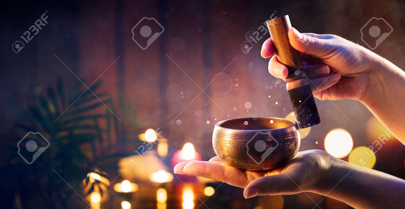 Woman Hands Playing Tibetan Singing Bowl - Translation of mantras: transform your impure body, speech, and mind into the pure exalted body, speech, and mind of a Buddha - 168103920 Woman Hands Playing Tibetan Singing Bowl - Translation of mantras: transform your impure body, speech, and mind into the pure exalted body, speech, and mind of a Buddha - 168103920