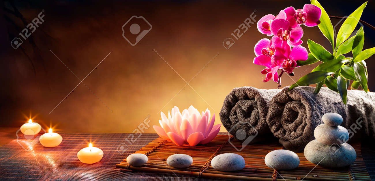 Spa Massage Treatment With Towels And Candles On Mat - 169657750 Spa Massage Treatment With Towels And Candles On Mat - 169657750