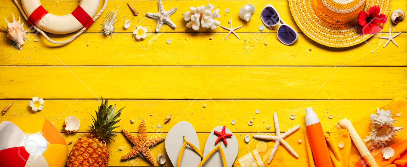 Yellow Beach Background With Accessories On Wooden Table - 169657762 Yellow Beach Background With Accessories On Wooden Table - 169657762