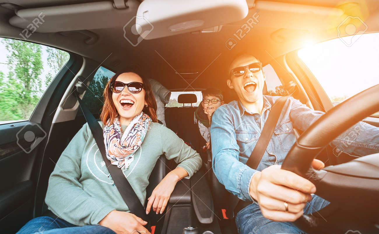 Cheerful young traditional family has a long auto journey and singing aloud the favorite song together. - 114529648 Cheerful young traditional family has a long auto journey and singing aloud the favorite song together. - 114529648