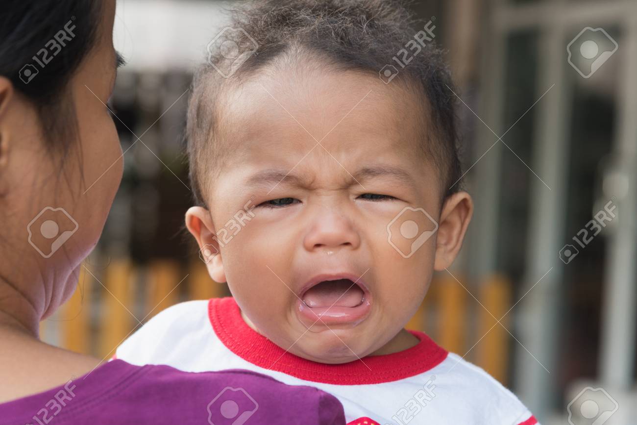 泣いている赤ん坊を保持している後ろから母 お母さんは 赤ちゃんを癒します 赤ちゃんが泣いています の写真素材 画像素材 Image