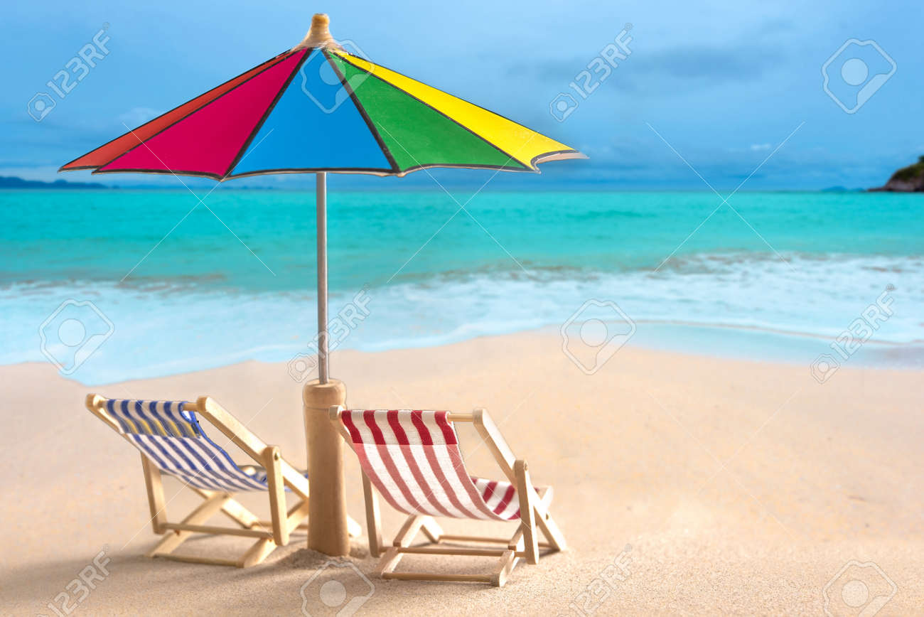 Beach Chairs And With Umbrella And Beautiful Beach On A Sunny