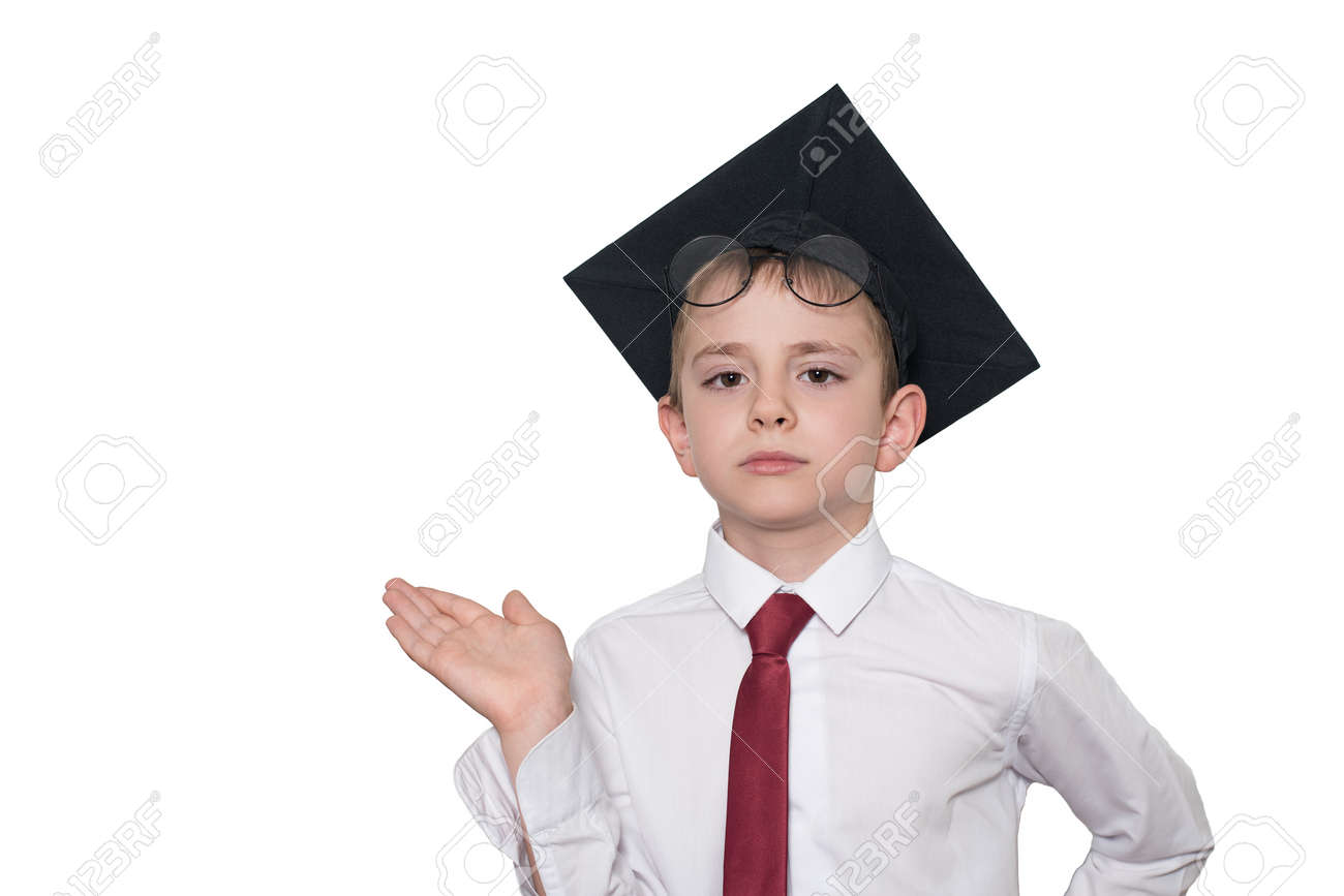 Boy in a square academic hat and glasses holds his palm up. School concept. Isolate - 126244502 Boy in a square academic hat and glasses holds his palm up. School concept. Isolate - 126244502