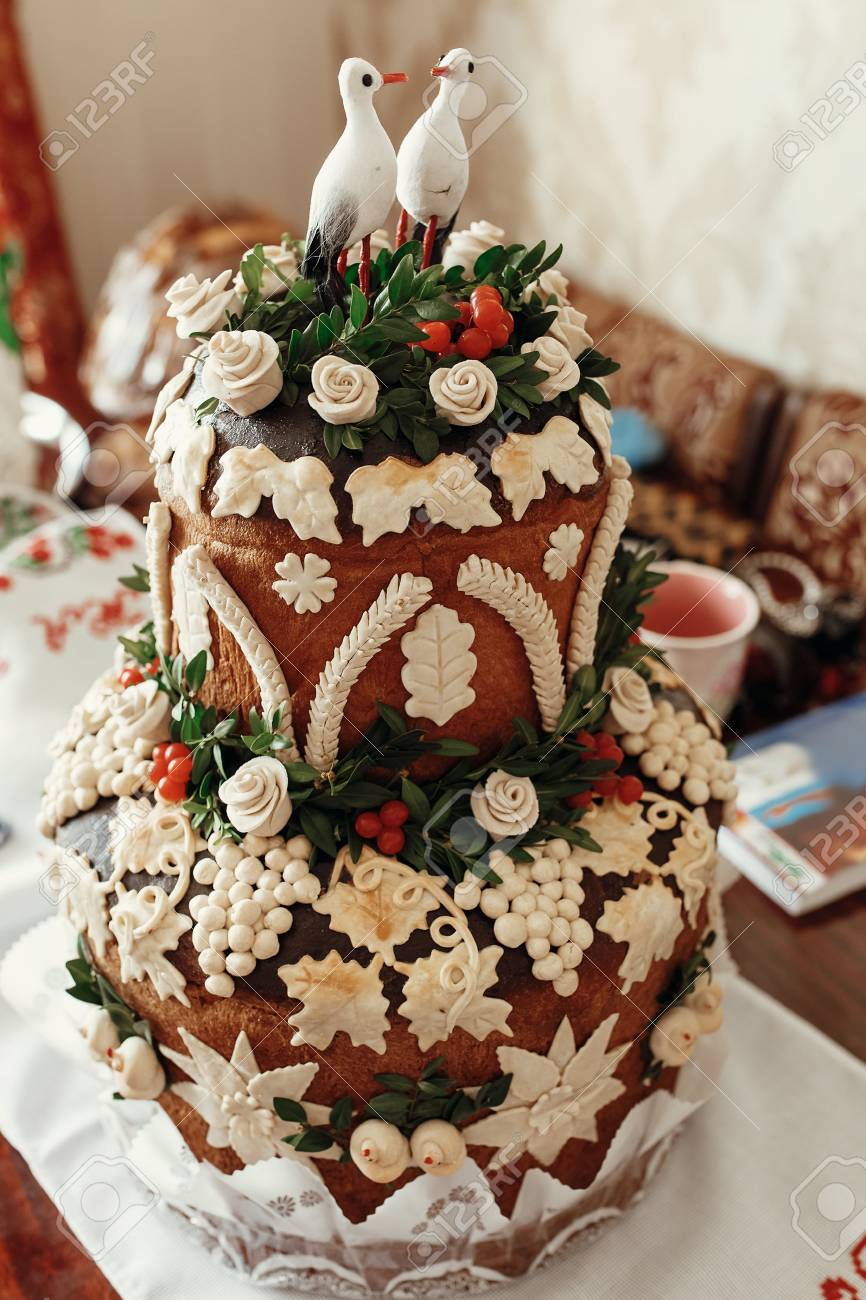 Beautiful Cake With Storks On Top Decorated With Red Roses And