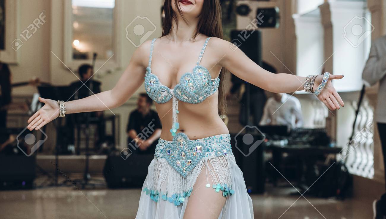 Sexual Belly Dancer. Eastern Dancing. Woman In Blue Costume Performing  Eastern Dance. Beautiful Woman Dancing At Wedding Reception In Restaurant.  Show Program Stock Photo, Picture and Royalty Free Image. Image 87991503.