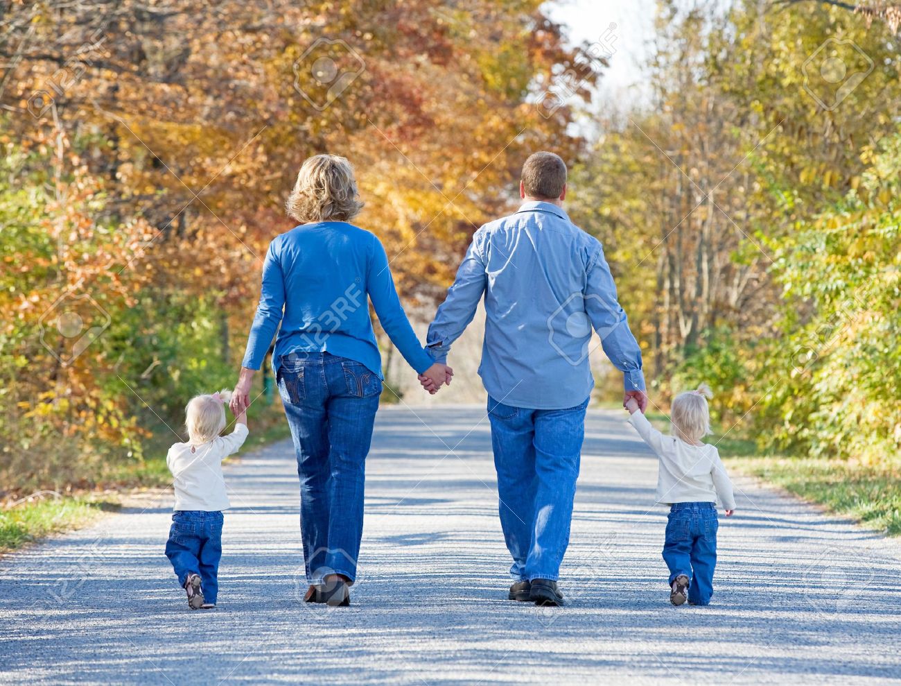 Family Taking a Walk in the Autumn - 5572519 Family Taking a Walk in the Autumn - 5572519