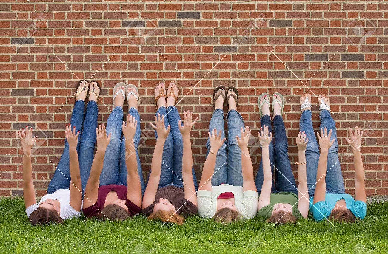 Group of College Girls at School With Legs up on Wall - 5931371 Group of College Girls at School With Legs up on Wall - 5931371