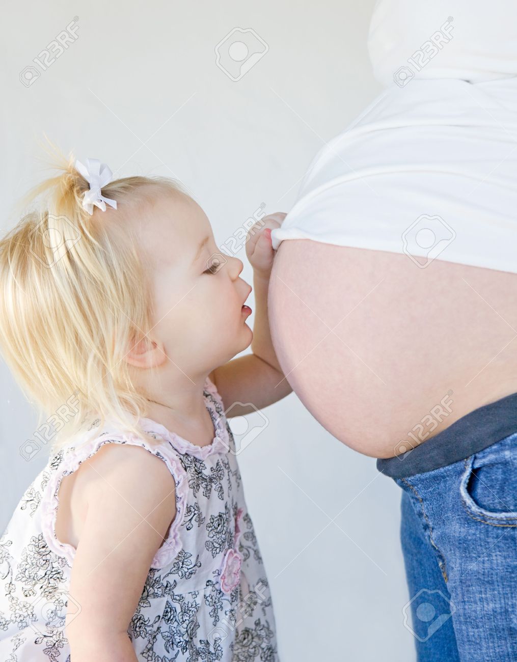 Little Girl Kissing New Sibling to Be - 6347339 Little Girl Kissing New Sibling to Be - 6347339