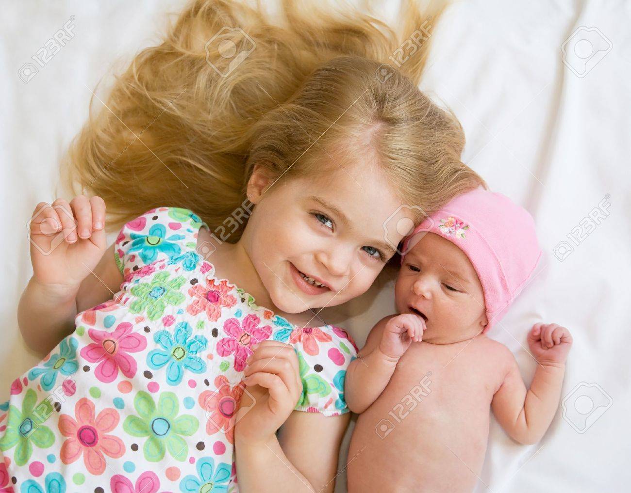 Sister Laying with New Baby Sister - 7011826 Sister Laying with New Baby Sister - 7011826