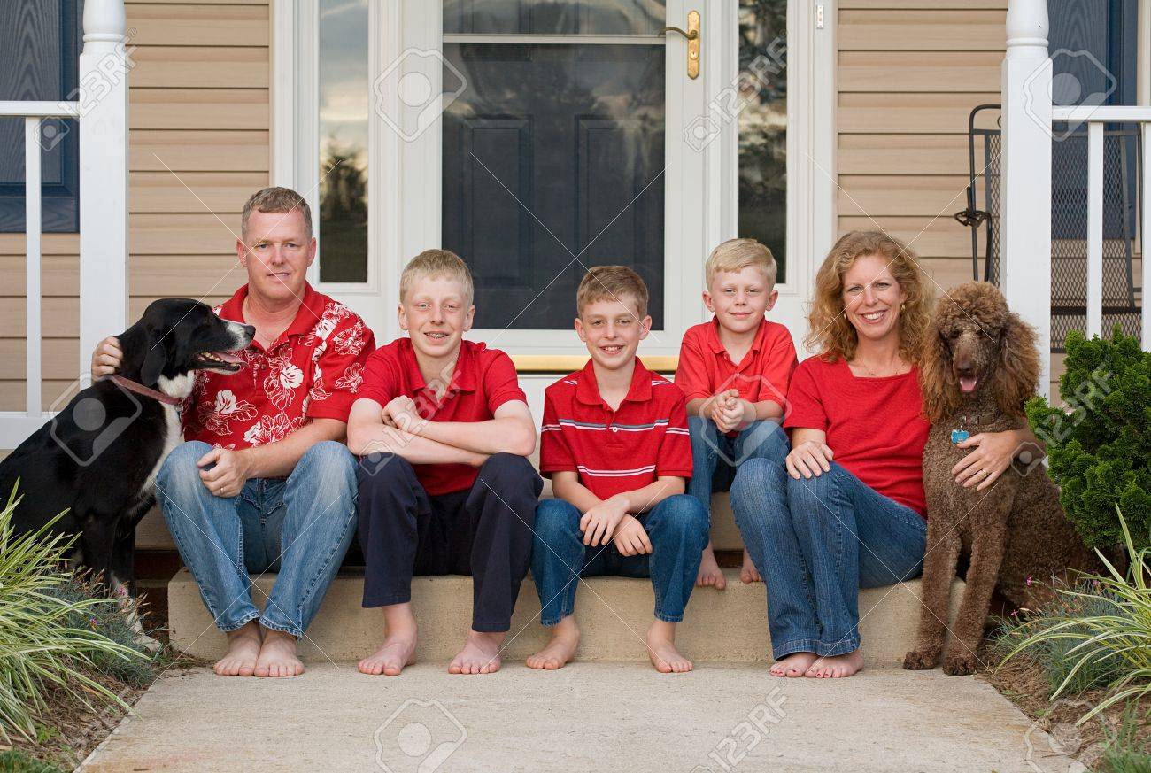 Happy Family in Front of Their Home - 7523378 Happy Family in Front of Their Home - 7523378