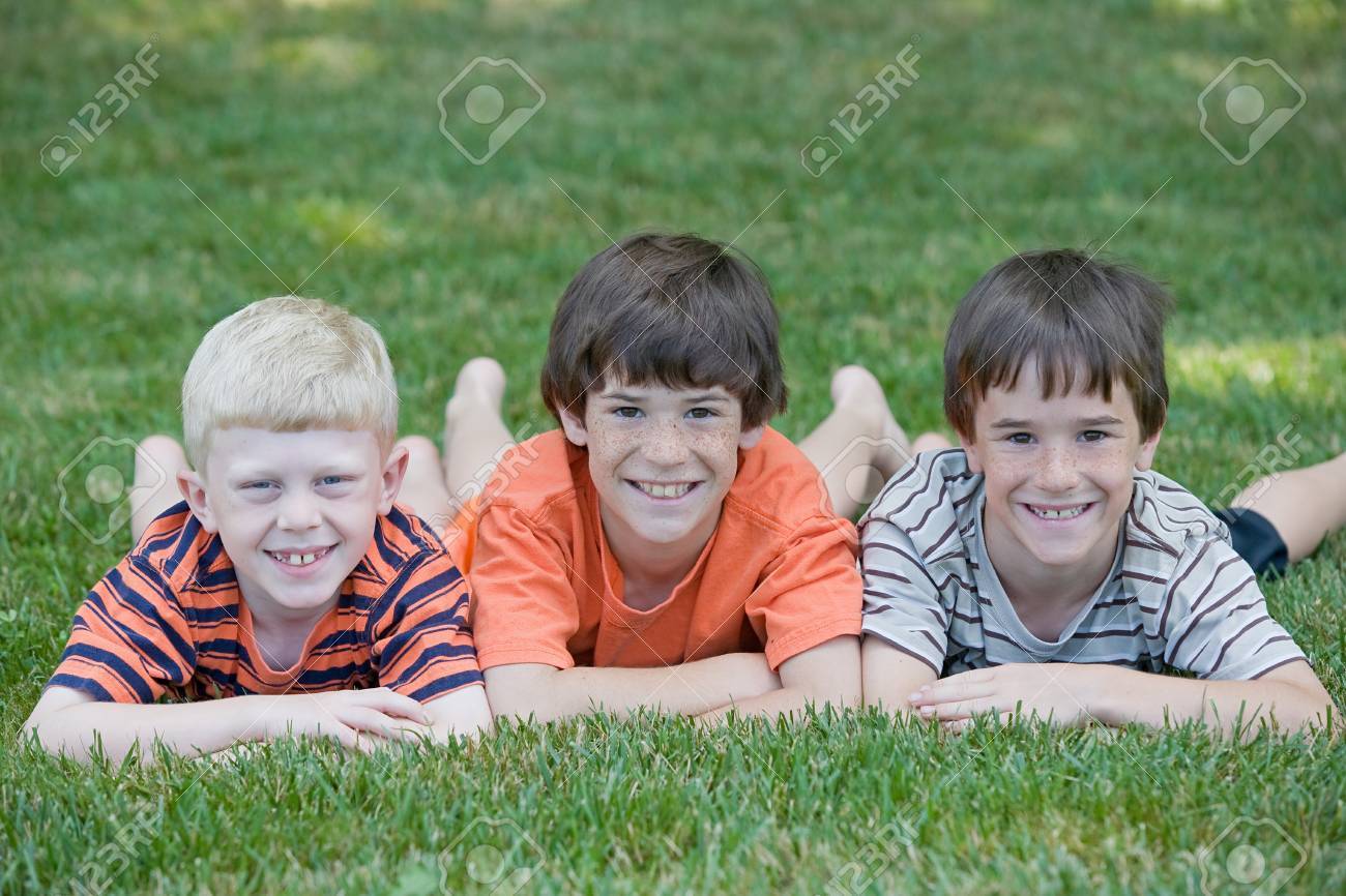 Three Cousins Laying in a Row Smiling Big - 7538939 Three Cousins Laying in a Row Smiling Big - 7538939