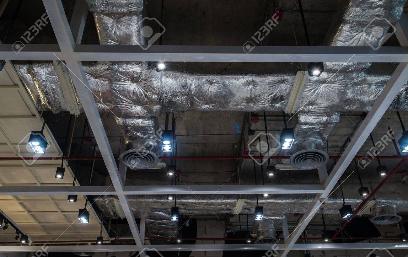 Ventilation system pipes on the ceiling of a modern factory plant building. - 48539934 Ventilation system pipes on the ceiling of a modern factory plant building. - 48539934