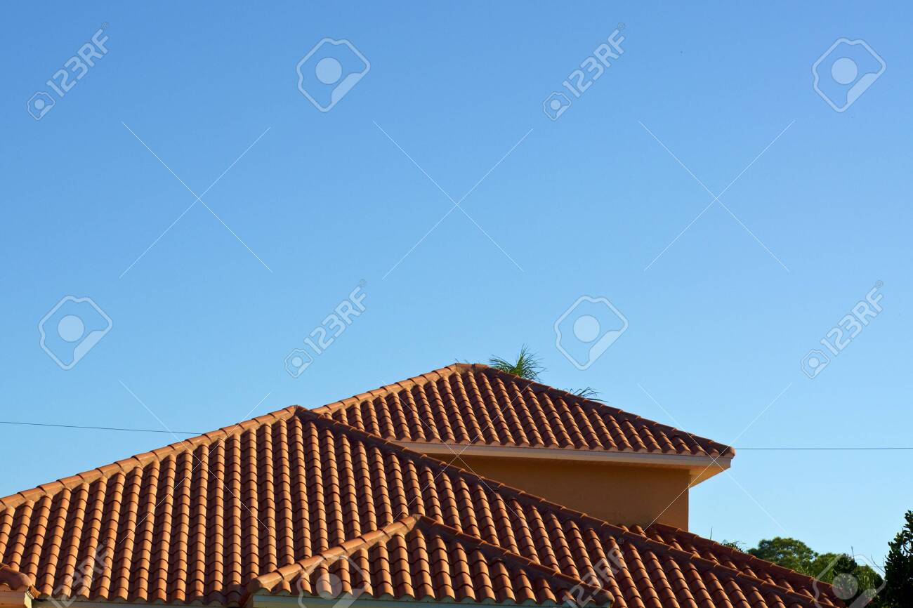 View Of Orange Terra Clay Roof Tops Against A Clear Blue Sky In Bonita Florida With Deep Shadows From Morning Light. Stock Photo, Picture And Royalty Free Image. Image