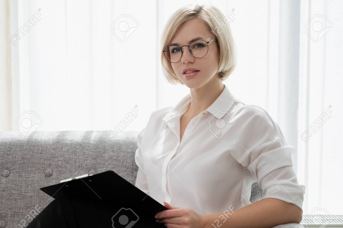 Young Beautiful Blonde Girl With Short Hair In A White Shirt