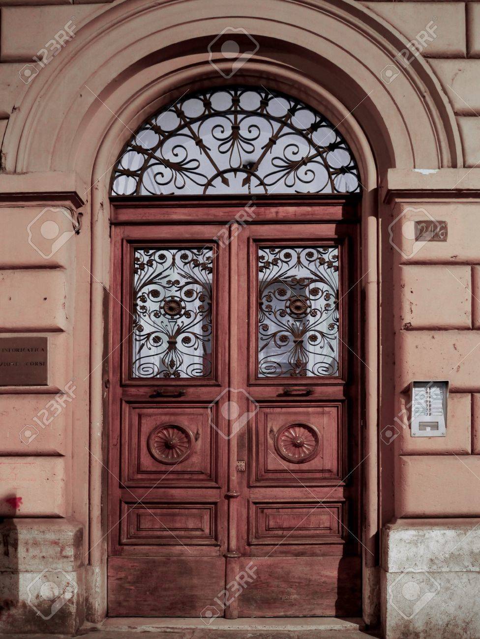 Apartment Building Door rome, italy, october 2011 - wooden double door of old apartment Apartment Building Door rome, italy, october 2011 - wooden double door of old apartment