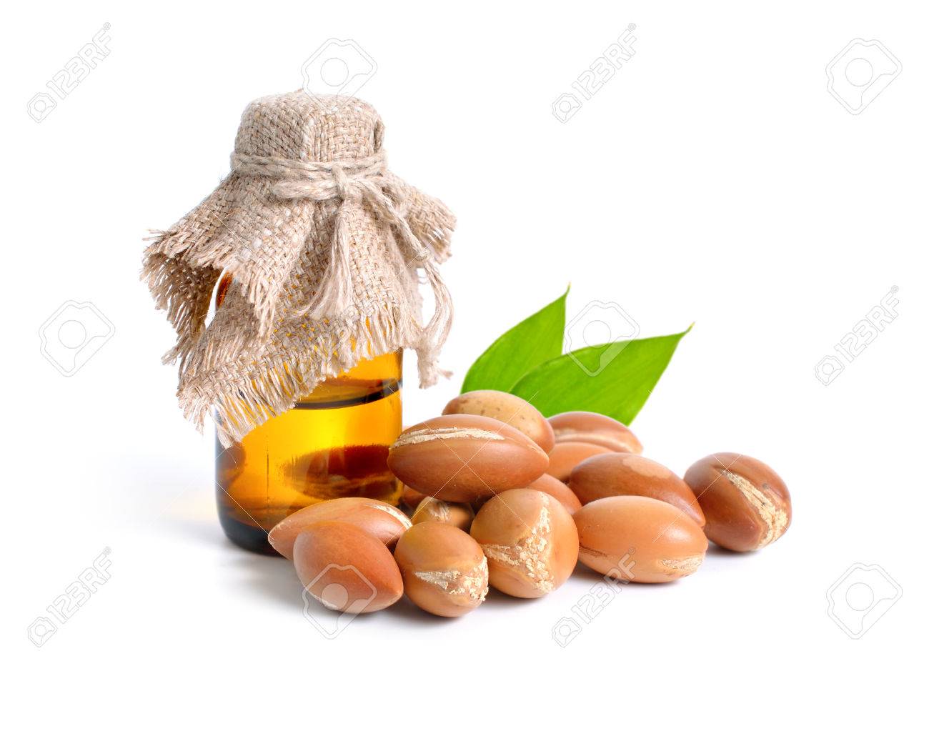Argan seed with pharmaceutical bottle. Isolated on white background. - 77209739 Argan seed with pharmaceutical bottle. Isolated on white background. - 77209739