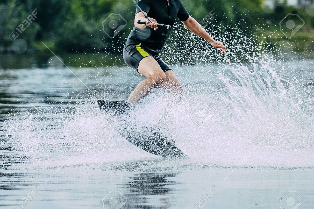man jumps on wakeboard wave. summer lake - 49933766 man jumps on wakeboard wave. summer lake - 49933766