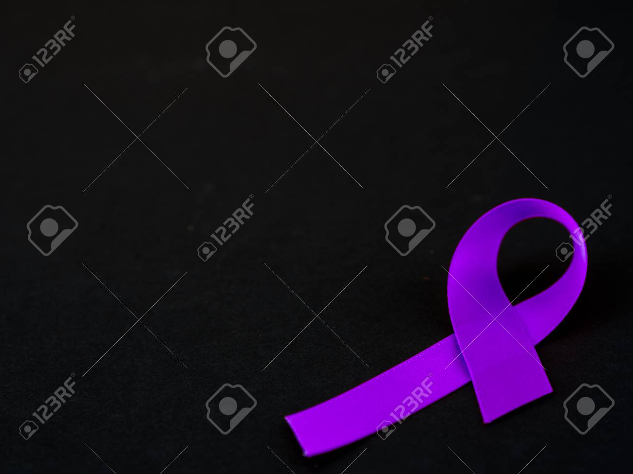 purple ribbon awareness on black background for world cancer stock black and purple ribbon