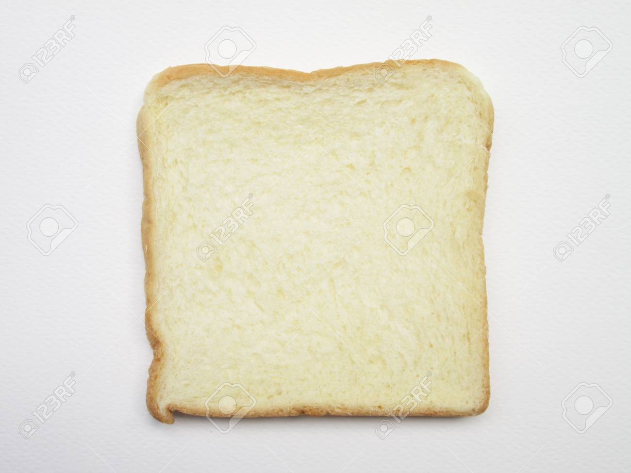 Close Up Image Of One Slice Of White Bread Against The Paper Stock
