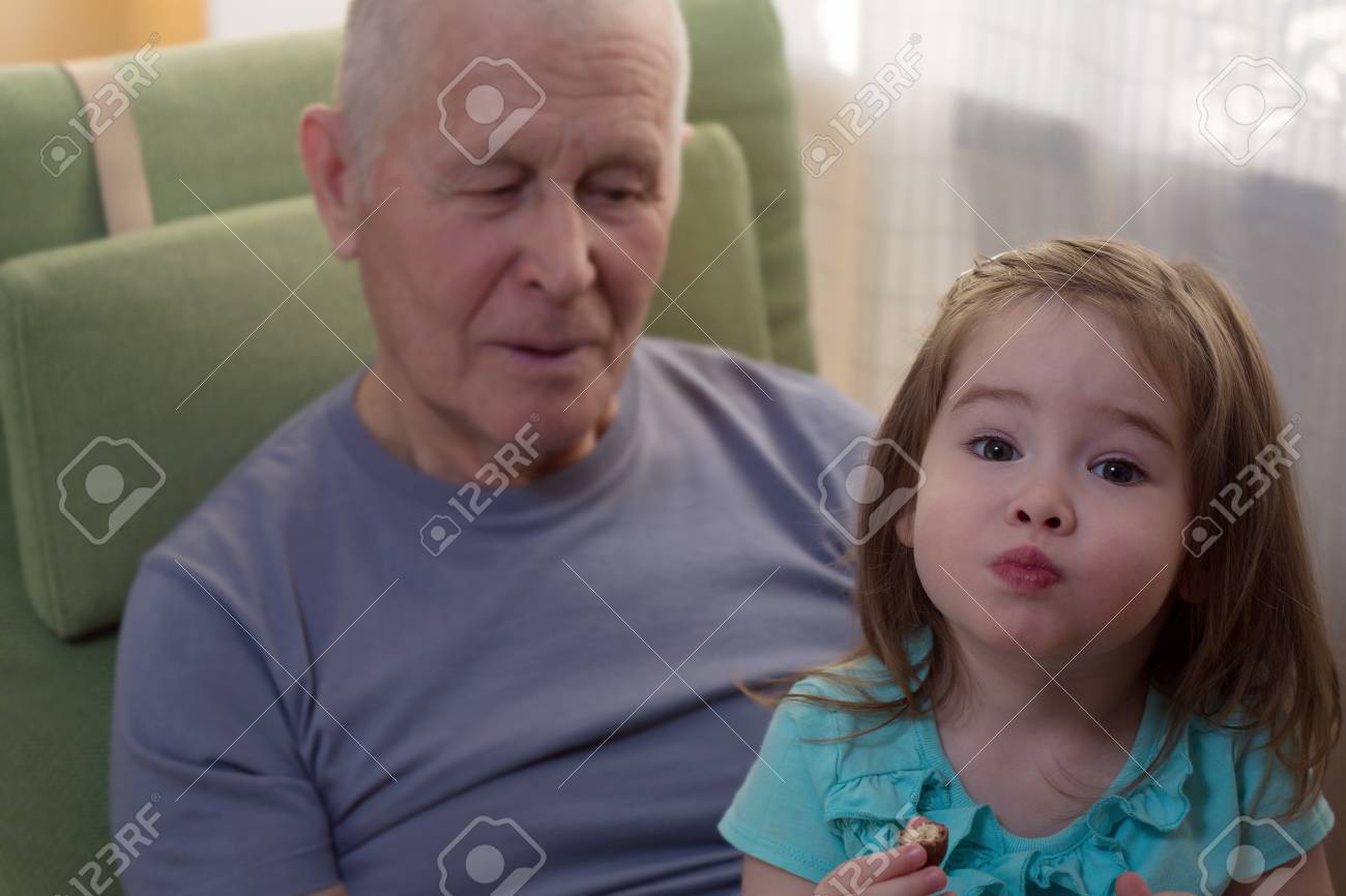 Cute little girl sitting with her grandfather - 34831925 Cute little girl sitting with her grandfather - 34831925