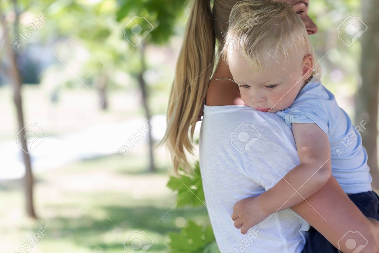 Outdoor portrait of mother and sad crying son in a summer park - 48600309 Outdoor portrait of mother and sad crying son in a summer park - 48600309