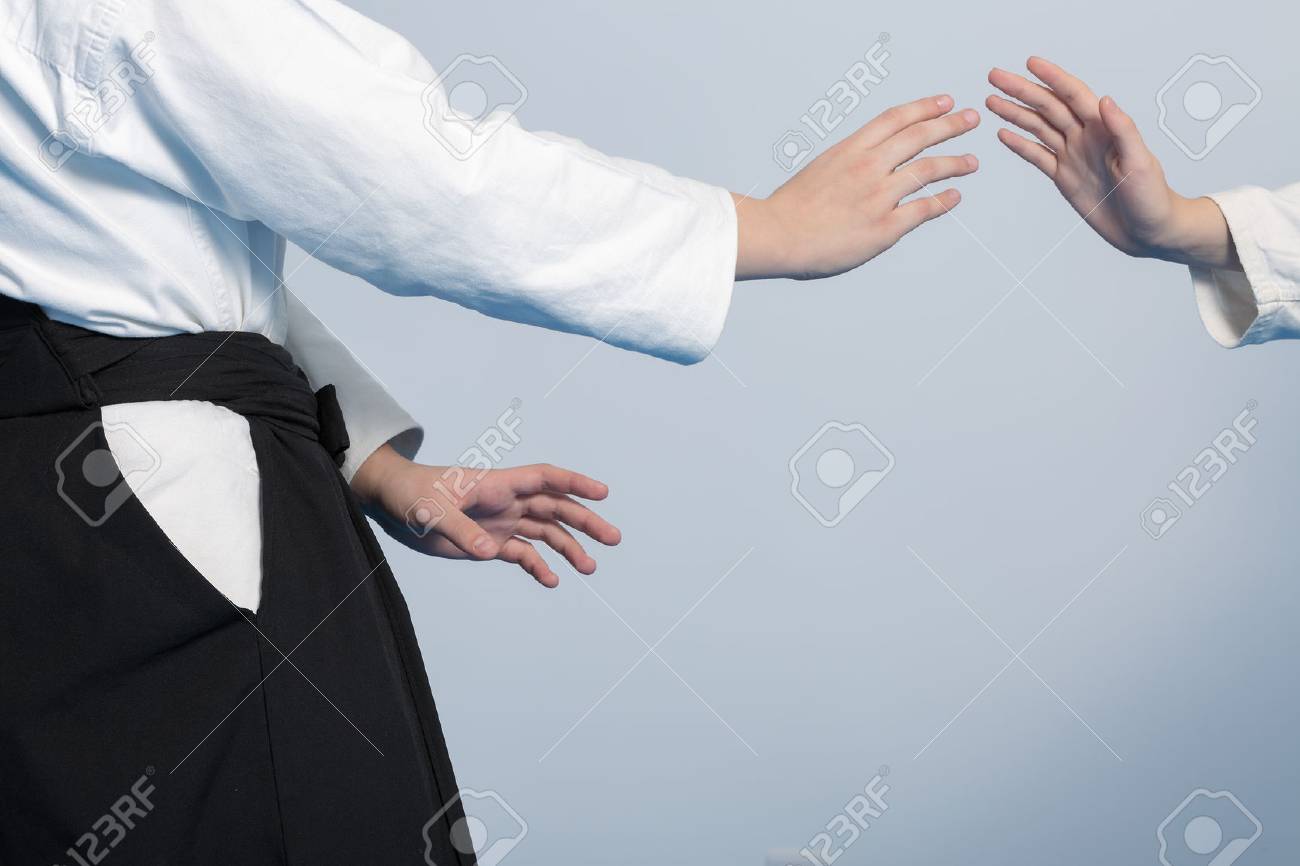 Hands of two girls standing in a stance on martial arts training - 49715454 Hands of two girls standing in a stance on martial arts training - 49715454